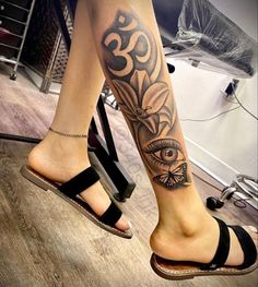 a woman's leg with an eye tattoo on it