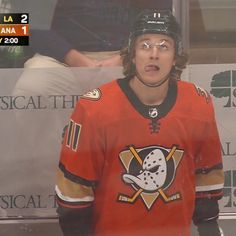 an image of a hockey player that is on the sidelines with his mouth open