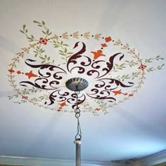 the ceiling is decorated with flowers and birds on it's side, while a chandelier hangs from the ceiling