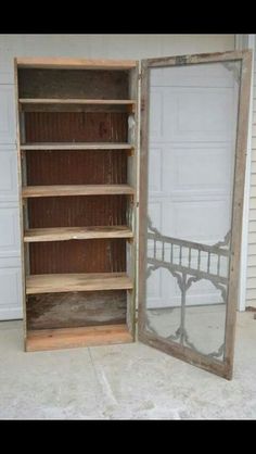 an old wooden bookcase is opened to reveal a mirror