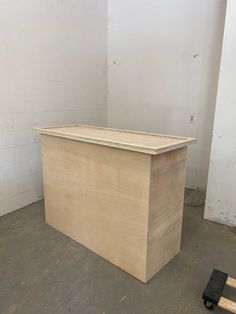 a large wooden box sitting on top of a floor