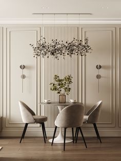 an elegant dining room with white walls and wood flooring, round table surrounded by grey chairs