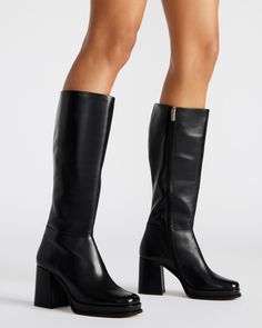 Crafted for ultimate sophistication, these knee-high boots boast a sleek square toe and sturdy block heel for effortless style. Elevate your wardrobe with the MYSTERY platform boot. 3.25 inch heel height 1 inch platform Size 6 measurements: 14 inch shaft circumference, 14.25 inch shaft height Size 8 measurements: 15.5 inch shaft circumference, 15 inch shaft height Size 10 measurements: 16 inch shaft circumference, 15.5 inch shaft height Leather upper material Textile and synthetic lining Synthet Knee High Black Heel Boots, Chic Knee-high Boots With Chunky Platform, Knee-high Platform Boots With Block Heel, Knee-high Chunky Platform Heeled Boots Medium Width, Tall Platform Boots For Fall, Trendy Knee-high Boots With Chunky Platform And Block Heel, Knee-high Chunky Platform Heeled Boots, Tall Platform Boots With Stacked Heel And Wide Calf, Wide Calf Tall Platform Boots With Stacked Heel