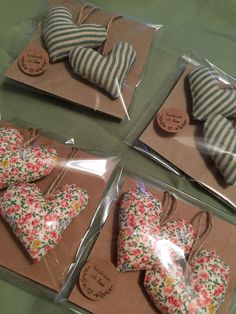 four pieces of heart shaped cookies are wrapped in cellophane