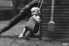 a young child swinging on a swing set