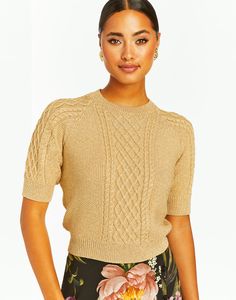 Cropped cable knit sweater with fitted crew neckline, short sleeves, and raglan shaping Metallic knit with lurex yarns 5% Metallic Lurex, 65% Polyester Wash instructions: Do not wash, Do not bleach, Do not tumble dry, Dry clean only, Iron low heat Model height is 5’9 | Sweater length from shoulder to hem is 17.5" Lurex Sweater, Cropped Cable Knit Sweater, Metallic Knit, Cable Knit Sweater, Cropped Sweater, Model Height, Crew Neckline, Cable Knit, Knit Sweater