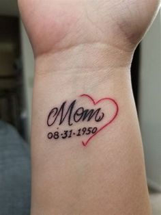 a woman's wrist tattoo with the word mom written on it