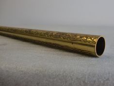 an ornate gold pipe is laying on the floor next to it's sidewall