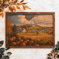 a painting hanging on the wall with leaves around it