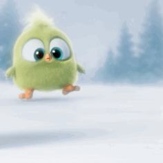 a green bird with big eyes walking in the snow