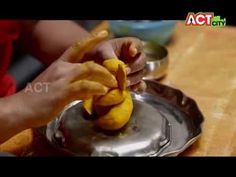 a person is peeling bananas on a metal plate