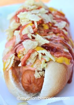 a hot dog covered in condiments and toppings