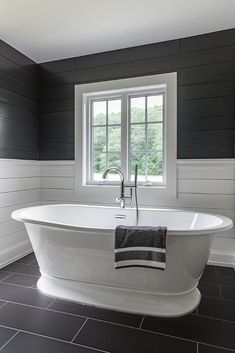 a white bath tub sitting next to a window