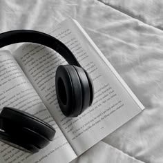 an open book with headphones on top of it