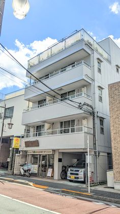 an apartment building with cars parked in front