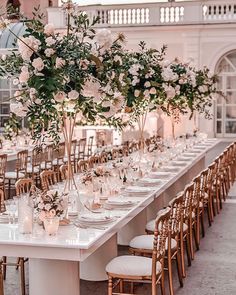 a long table is set with white flowers and candles for an elegant wedding reception at the grand america hotel