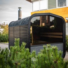 a house that is made out of wood and has a large window on the side