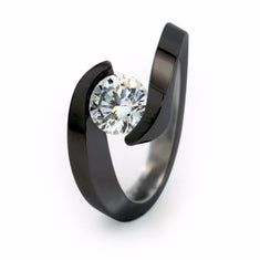 a black ring with a white diamond in it