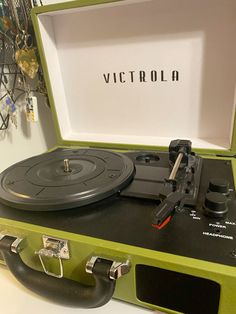 an old record player in a green case