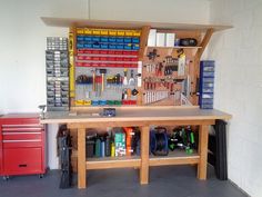 a workbench with tools and other items on the table in front of it