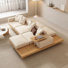 a living room filled with furniture and a table in front of a large window on top of a carpeted floor