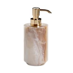 a soap dispenser with a golden faucet and marbled body