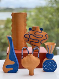 several vases sitting on top of a table next to each other