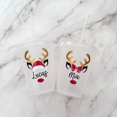 two plastic cups with reindeer faces on them