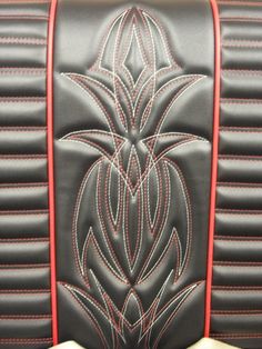 the interior of a car with black leather and red stitching on it's seat