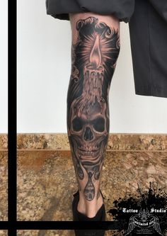 a man's leg with a skull tattoo on it