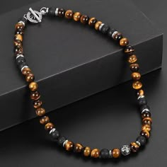 Product Specifications: --Type: Necklace --Material: Stainless Steel+ Lava Stone + Tiger Eye Stone --Color: Black / Gray --Metal: Stainless Steel --Chain Type: Ball / Bead --Style: Punk --Length: 18 / 20 / 24 Inches --Main Stone Shape: Round --Handmade: Yes --Cut Grade: Excellent --Shape: Round --Occasion: Christmas, Anniversary, Birthday, Christening, Confirmation/Communion, Engagement, Father's Day, Graduation, Mother's Day, Valentine's Day, Wedding --Main Stone Color: Brown --Features: Beaded Mens Beaded Necklaces, Tiger Eyes, Tigers Eye Necklace, Mens Jewelry Necklace, Natural Stones Necklace, Neck Choker, Chain Fashion, Natural Stone Bracelets, Tiger Eye Beads