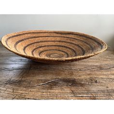 a wooden bowl sitting on top of a table