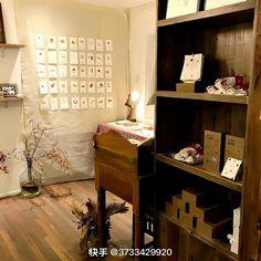 a room with wooden floors and shelves filled with boxes, papers and other things on it