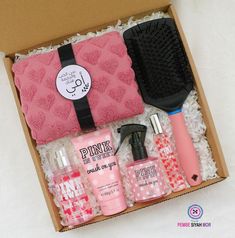 the pink box contains various items such as hair brush, lotion and hand soap