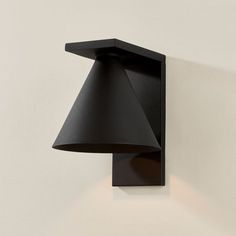 a black lamp mounted on the side of a wall