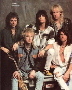 the group of young men are posing for a photo with their guitars and guitar heads