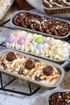 several trays filled with different types of desserts