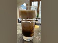 a glass filled with liquid sitting on top of a counter