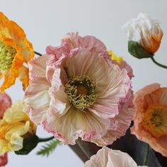 an arrangement of flowers in a vase on a table