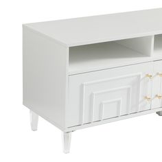 a white entertainment center with two doors and drawers on one side, an open drawer at the top