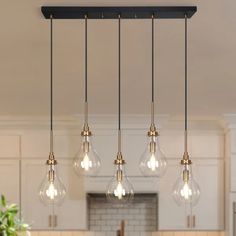 an image of a kitchen light fixture with five bulbs hanging from it's ceiling