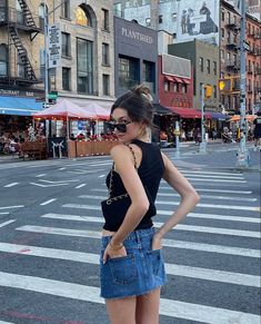 a woman standing in the middle of a street