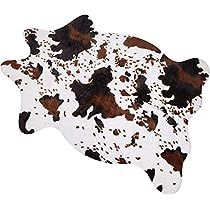 a brown and white spotted cow skin rug