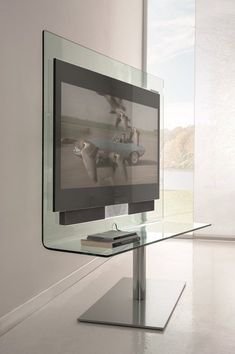 a flat screen tv sitting on top of a metal stand