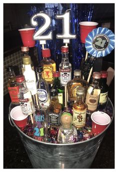 a bucket filled with lots of liquor bottles