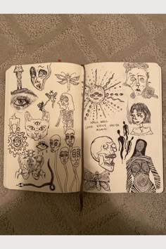 an open notebook with drawings on it sitting on top of a carpeted floor next to a wall