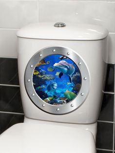 a white toilet with an underwater scene on the lid