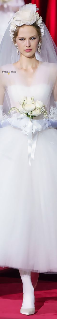 a woman in a white wedding dress and veil