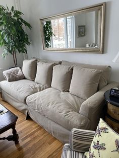 a living room filled with furniture and a large mirror