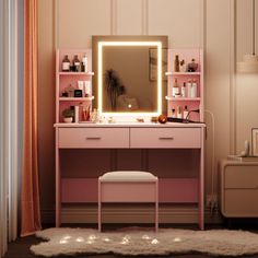 a pink vanity with lighted mirror, stool and lights on the wall behind it in a bedroom